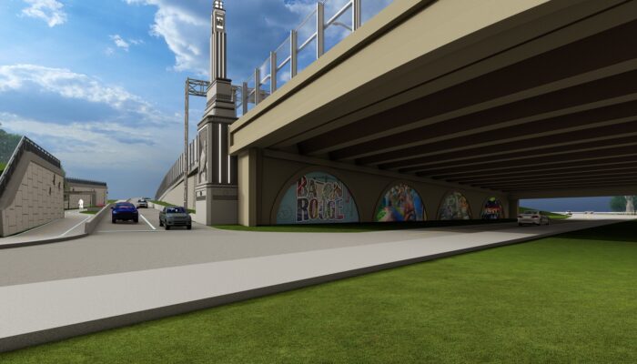 view of City Park Lake bridge from below, showing art on abutment